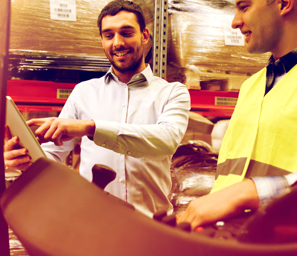 happy men with tablet pc and forklift at warehouse PR2CLBG min
